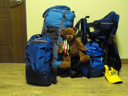 We've "simplified" our lives to this: a travel backpack, two daypacks, a baby carrier and Ian's teddy, Hudson Bear.